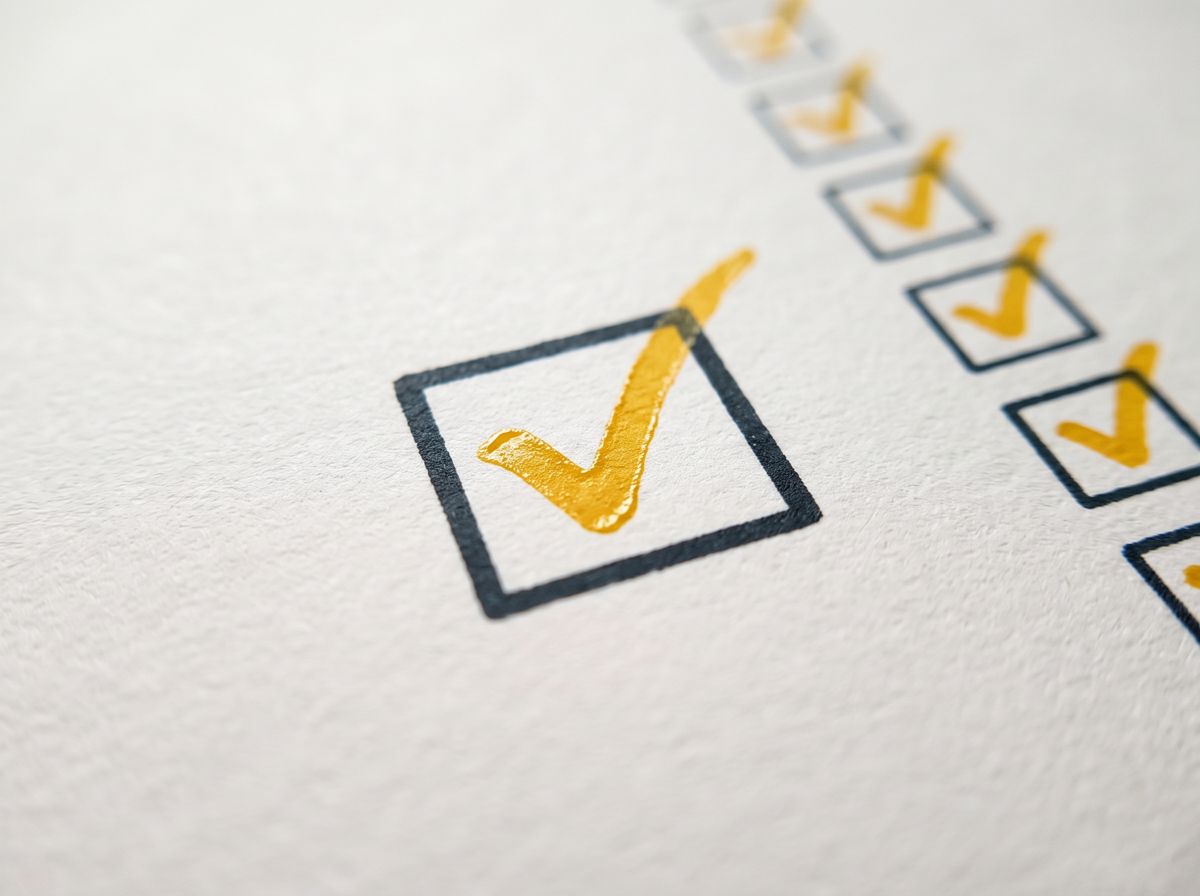 A ballot-yellow tick in a printed checkbox, with a row of ticked boxes behind it